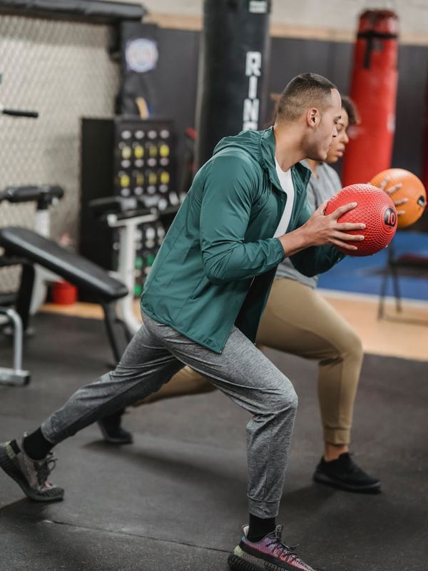 Man in a dynamic lunge pose in a spacious loft.